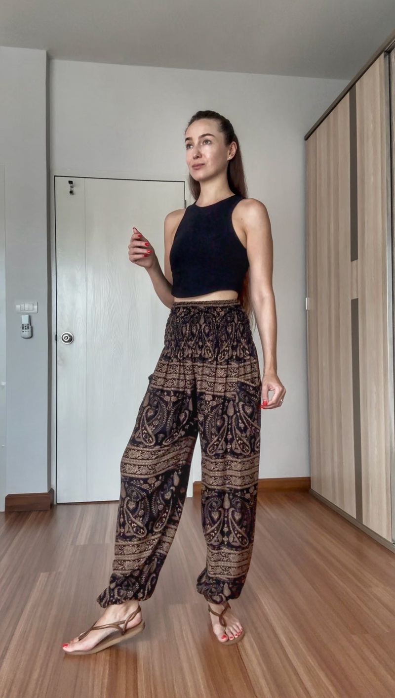 Creator wearing brown patterned pants with a black sleeveless top