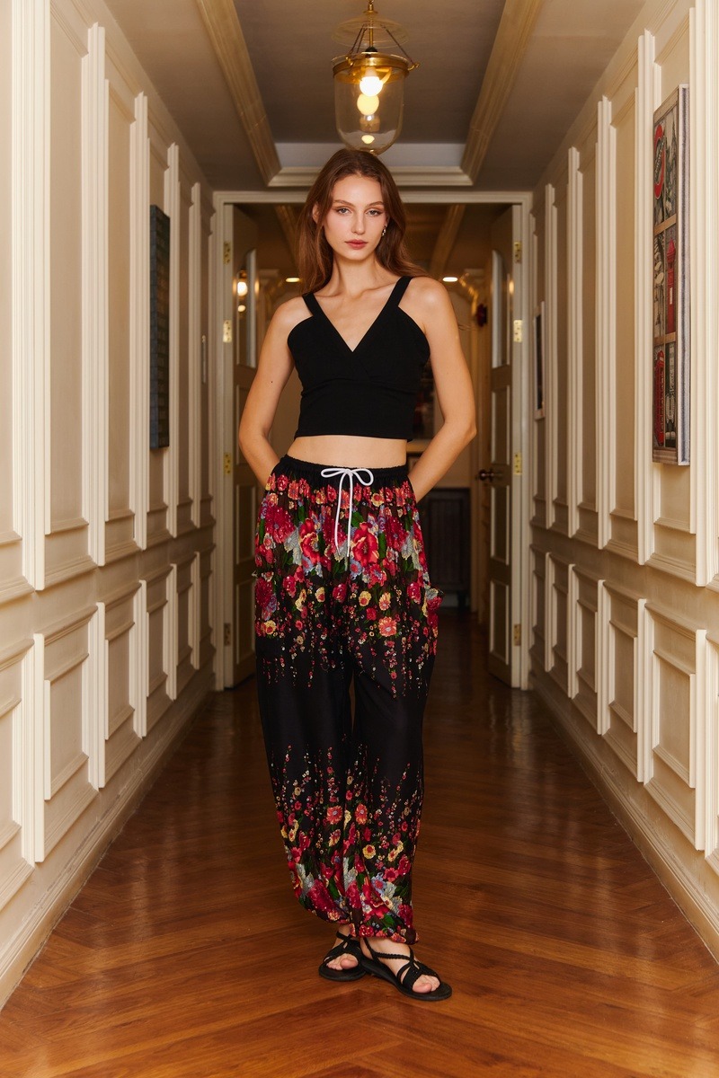 Floral pants styled in a hotel hallway